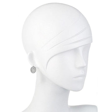 Silver drop earrings on a mannequin, featuring an ornate circular design.
