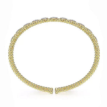 Gold beaded cuff bracelet adorned with small diamonds.
