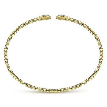 Gold beaded bangle bracelet with small hexagon accents.
