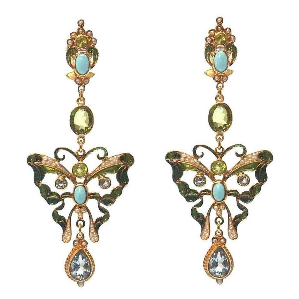Gold butterfly earrings with turquoise, peridot, and aquamarine gemstones.
