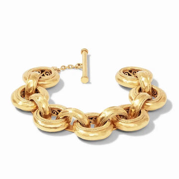 Gold Cassis Link bracelet with textured, interlocking circular links and a toggle clasp.
