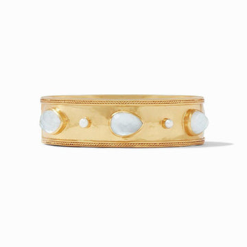 Gold statement bangle adorned with pearlescent stones.

