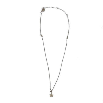 Dainty silver chain necklace with small flower pendant.

