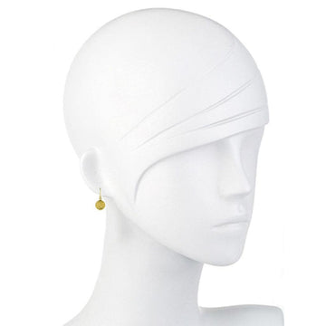 Gold disc drop earrings on a white mannequin.
