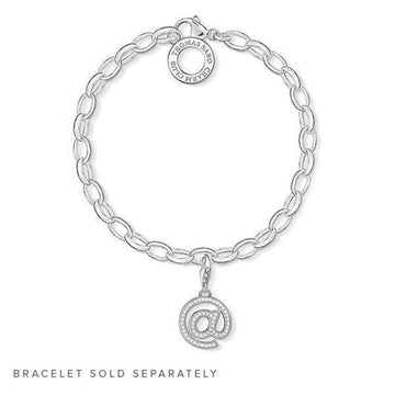 Silver ampersand charm with clear stones, hanging from a chain bracelet (sold separately).
