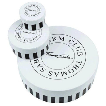 White round gift boxes with black stripes and logo, varying in size.
