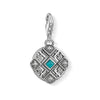 Charm 1421 Africa Ornament: Silver charm with turquoise stone, intricate geometric design.
