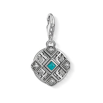Charm 1421 Africa Ornament: Silver charm with turquoise stone, intricate geometric design.
