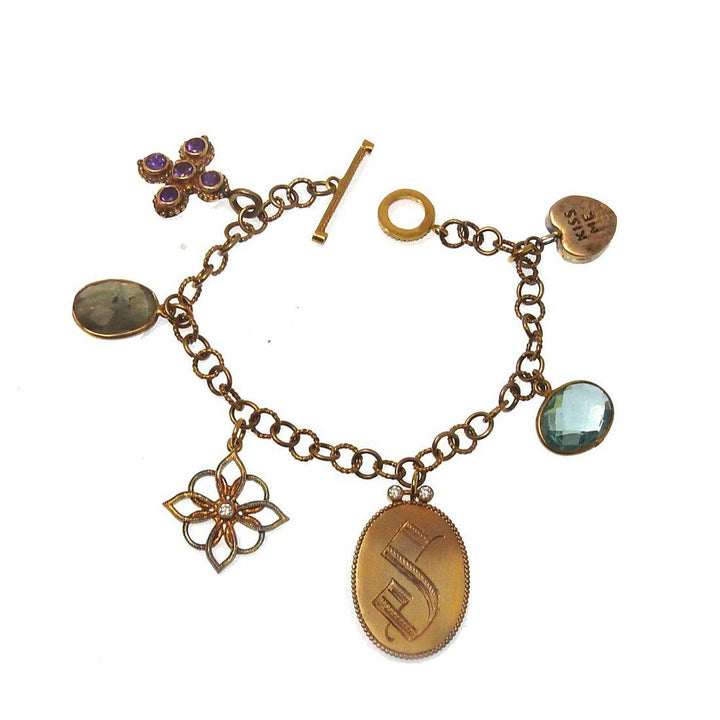 Bronze charm bracelet with amethyst, aquamarine, and other gemstones.
