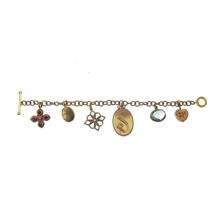 Bronze charm bracelet with amethyst and aquamarine accents.
