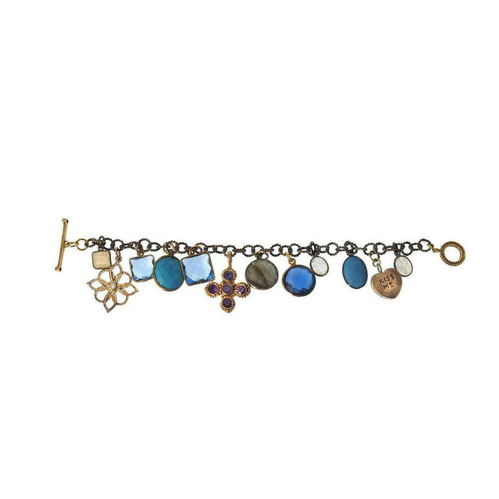 Multi-gemstone charm bracelet featuring blue, purple, and gold accents.
