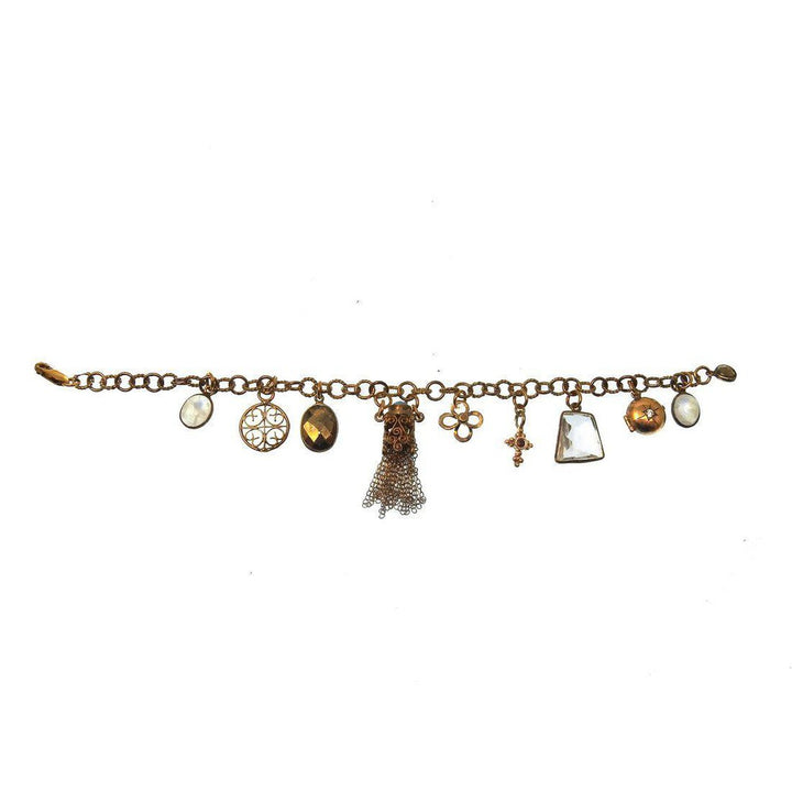 Gold charm bracelet featuring various pendants, including gemstones and etched designs.
