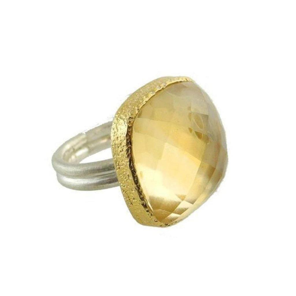 Gold-bordered citrine ring featuring a large, faceted gemstone.
