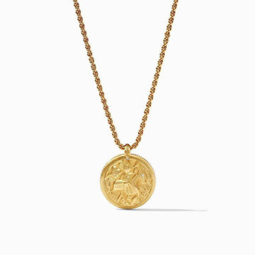 Gold statement necklace featuring a reversible coin pendant with intricate detailing.
