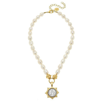 Elegant pearl necklace with gold accents and a bee coin pendant.
