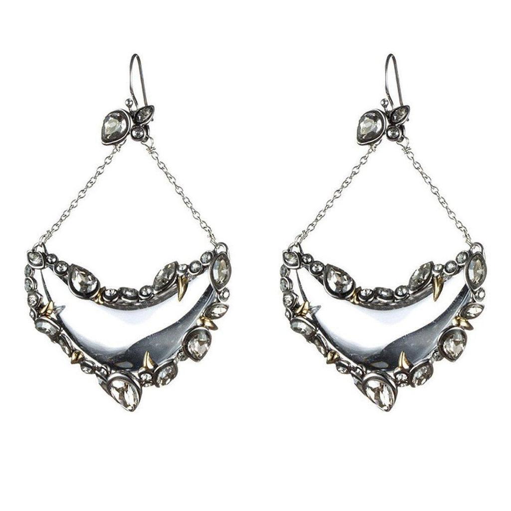 Silver crescent earrings with crystals and gold accents; statement jewelry.
