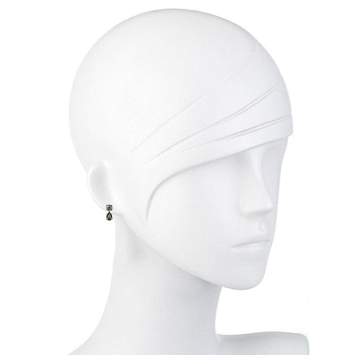 Dark gray crystal drop earrings on a mannequin.
