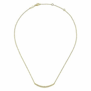 Delicate gold necklace featuring a curved row of sparkling diamonds.
