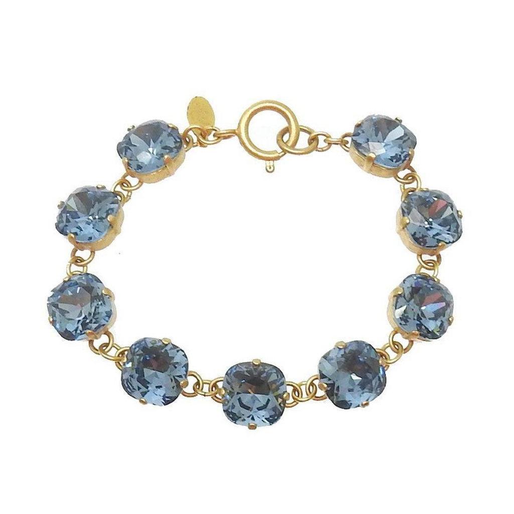 Montana Cushion Cut Tennis Bracelet: Gold chain, light blue crystals.
