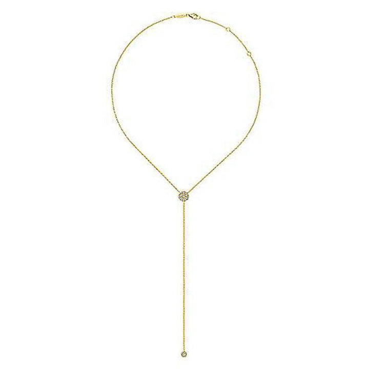 Long gold lariat necklace featuring a diamond-encrusted pendant.
