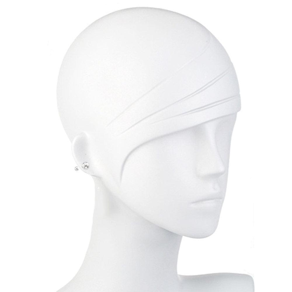 Simple silver ball stud earrings on a mannequin.

