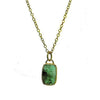 Emerald necklace with 18k gold chain and rectangular gemstone pendant.
