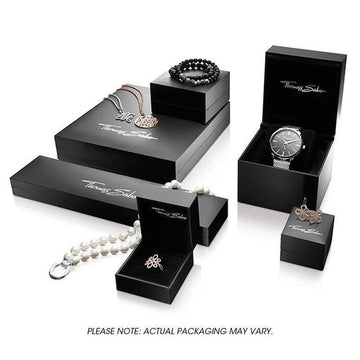 Elegant black jewelry boxes showcasing various pieces, including a bracelet, watch, necklace, and rings.
