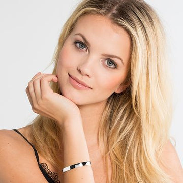 Woman's wrist wearing a sleek, engravable cuff bracelet.
