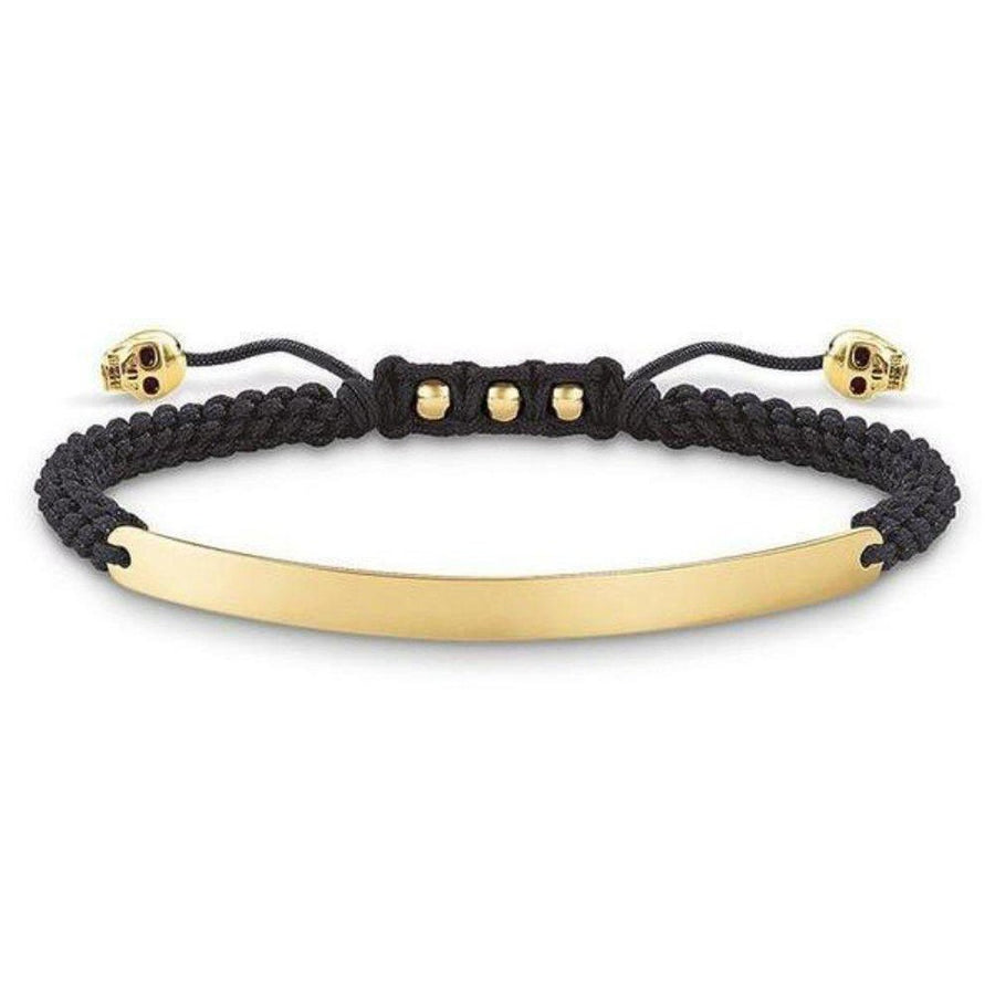 Engravable macrame bracelet with gold plate and skull accents.
