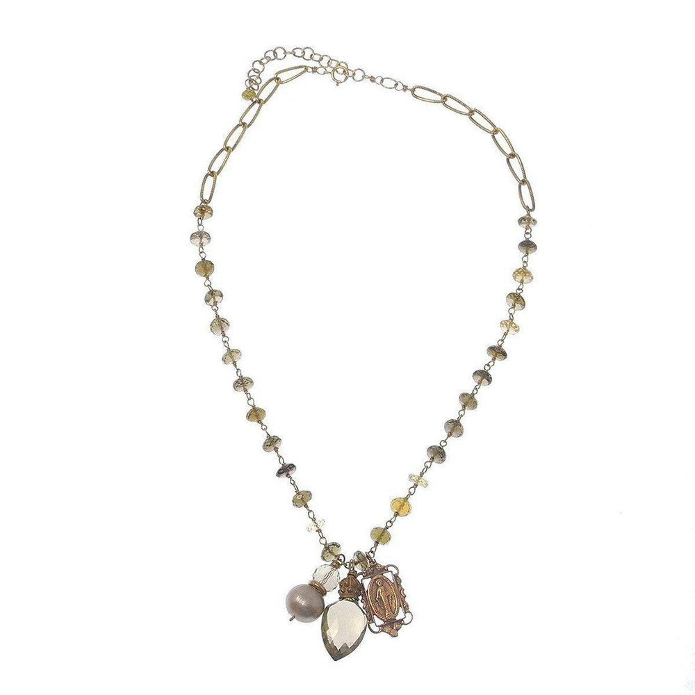 Faceted quartz and pearl necklace with Madonna charm, gold chain, on white background

