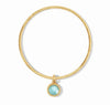 Gold Fleur-de-Lis bangle with light blue gemstone charm
