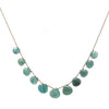 Teal gemstone necklace on brown cord, featuring teardrop-shaped stones.
