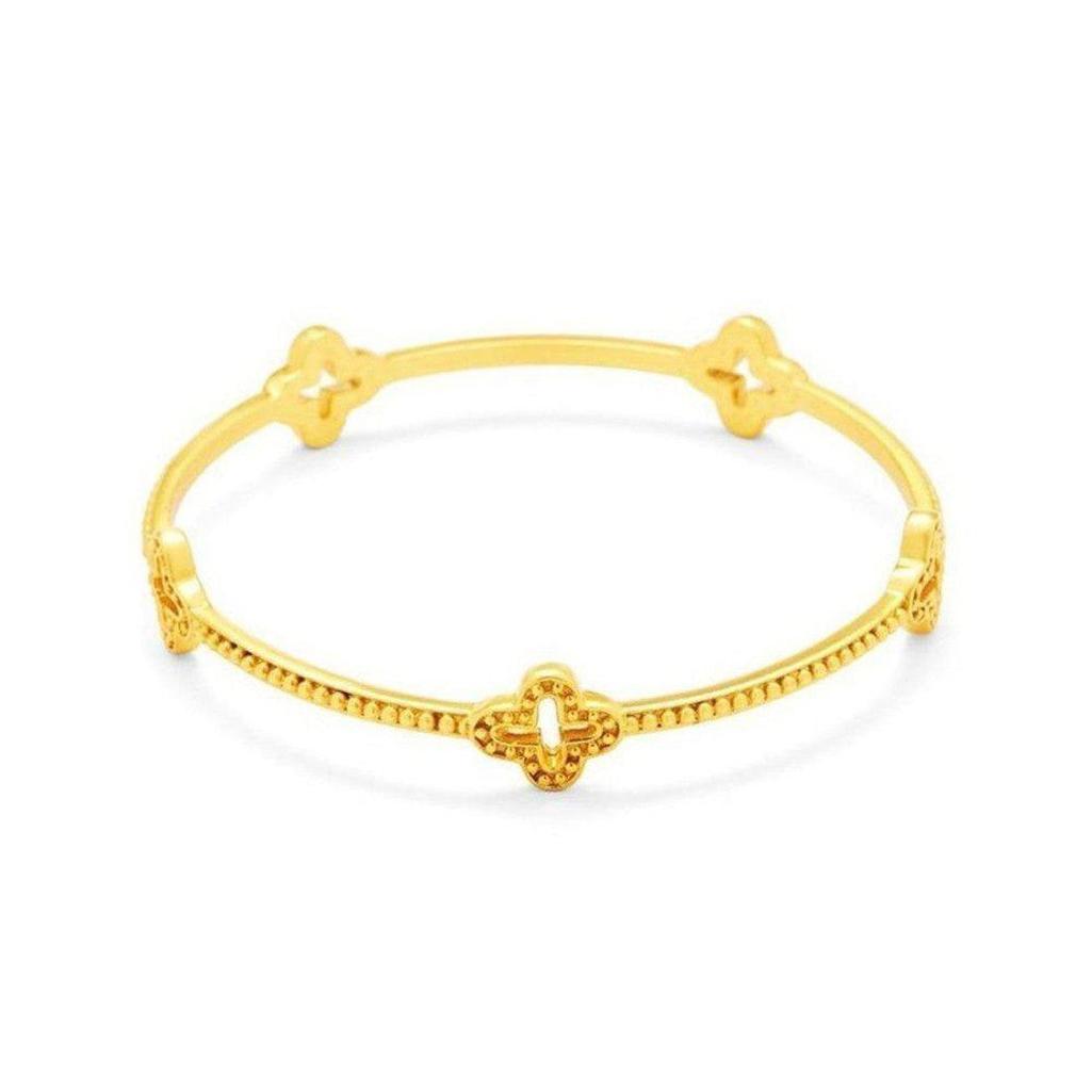 Gold Florentine bangle bracelet with textured detailing and four clover accents.
