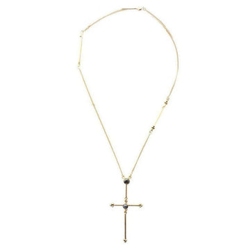 Gold cross necklace with dark gemstones, delicate chain.
