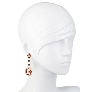 Red garnet and gold moon and star drop earrings on a mannequin.
