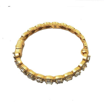 Gold hinged bangle bracelet adorned with sparkling stones.
