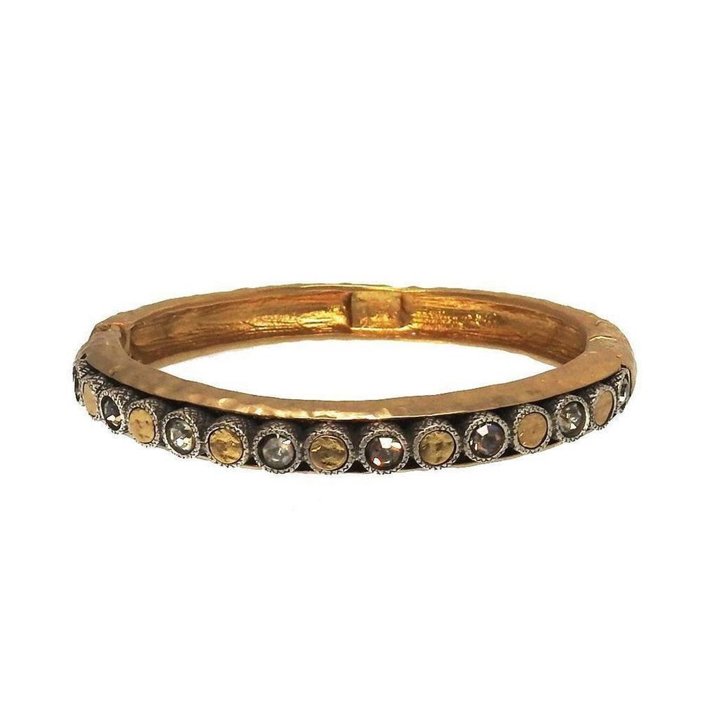 Gold hinged bangle bracelet with crystal accents.
