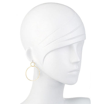 Double gold hoop earrings on a mannequin, showcasing a minimalist design.
