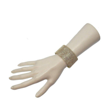 Gold crystal cuff bracelet on a mannequin wrist; sparkling, wide design.
