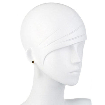 Gold vermeil hoop earrings with a small, dark centerpiece on a mannequin.
