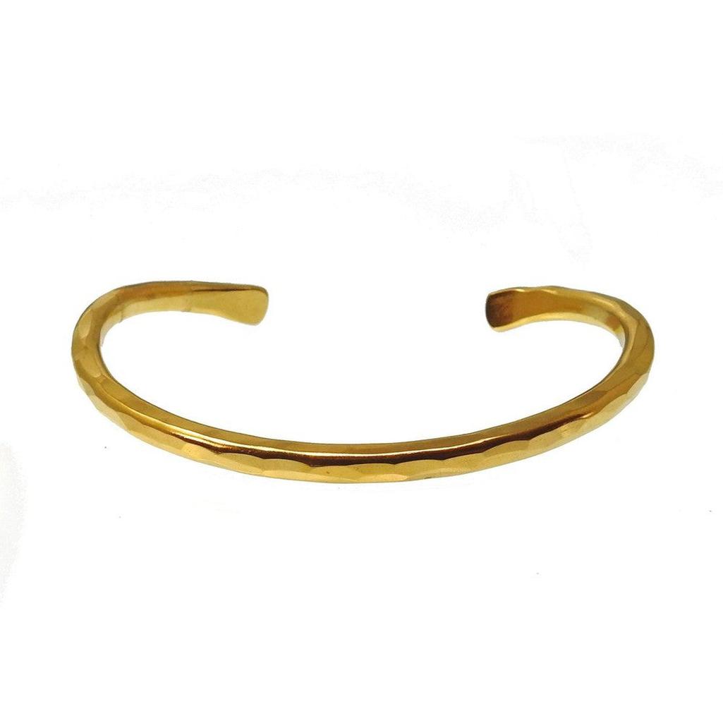 Hammered gold cuff bracelet with textured finish.
