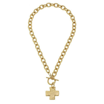 Gold toggle necklace with textured cross pendant on a thick chain.
