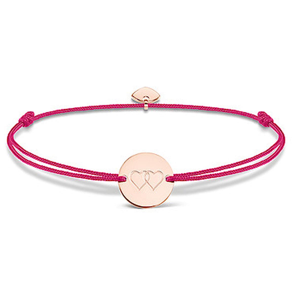 Rose gold heart medallion bracelet on a pink cord.
