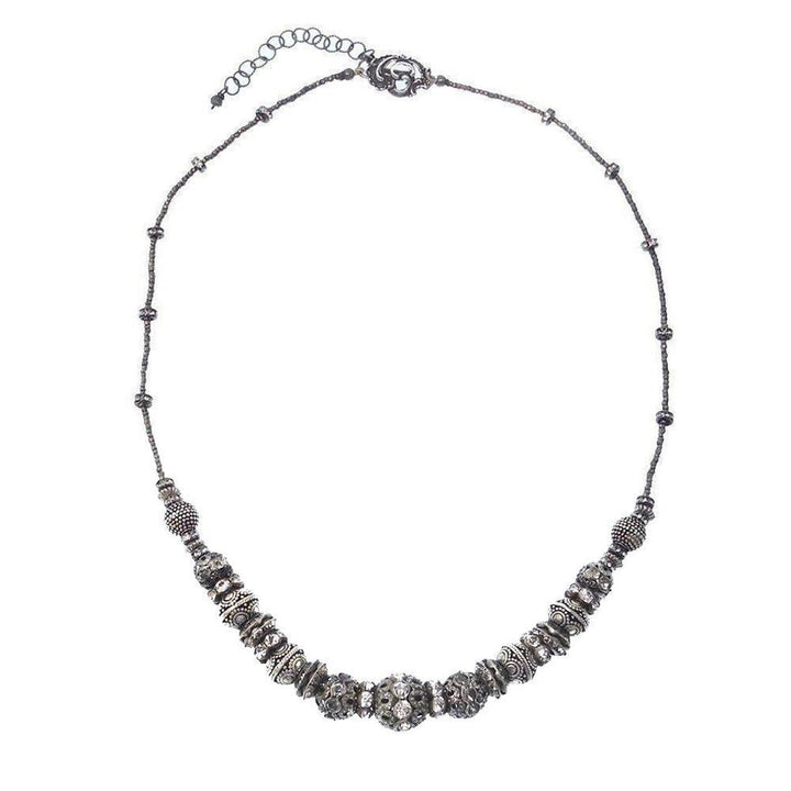 Elegant gunmetal Heishi necklace with sparkling crystal accents.
