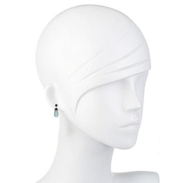 Teardrop gemstone earrings on a mannequin, showcasing light blue and dark gray stones.
