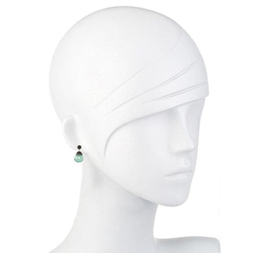 Elegant teardrop hematite earrings with a pale green stone, shown on a mannequin.
