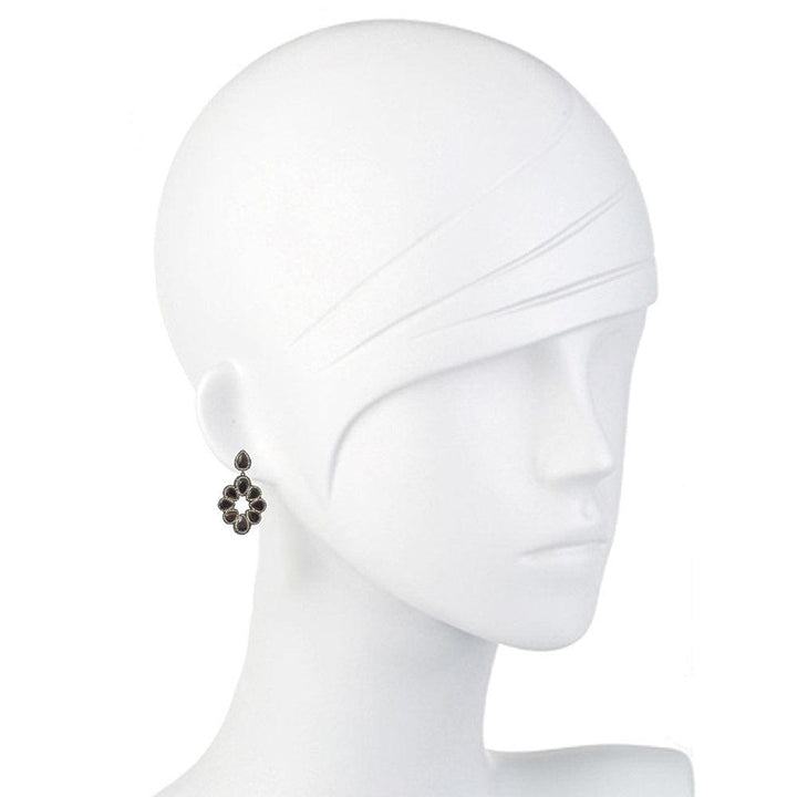 Dark gray hematite and crystal drop earrings on a mannequin.
