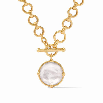 Gold toggle necklace with a large, round mother-of-pearl pendant.

