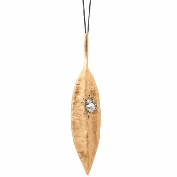 Gold leaf pendant necklace featuring a silver beetle detail.
