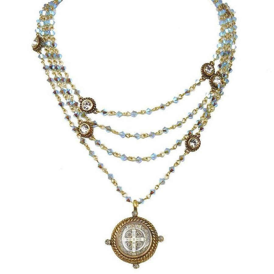 Multi-strand iridescent blue crystal necklace with antique gold accents and a St. Jude medal pendant.
